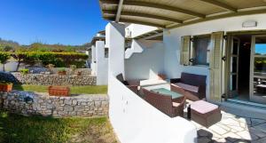 a house with a patio with chairs and a porch at To Pithari in Skiros