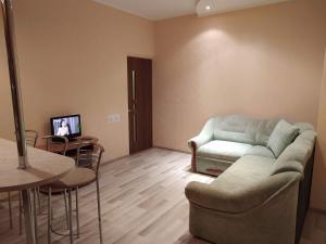 uma sala de estar com um sofá e uma mesa em Двухкомнатная квартира с кухней студией Бровары. em Brovary