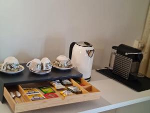 a kitchen counter with a tea kettle and dishes at Suite del Mercante in Mantova