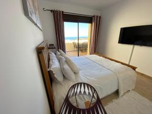 a bedroom with a bed with a view of the ocean at Duquesa village El Hacho in Manilva