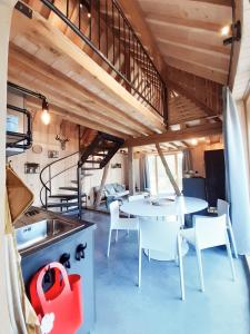 a kitchen and dining area of a tiny house at Boerderaaj vakantiewoning in Bilzen