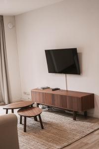 a living room with a flat screen tv on a wall at Central and Cozy in Brussels in Brussels +128 photos