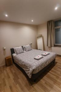 a bedroom with a bed with two plates on it at Central and Cozy in Brussels in Brussels