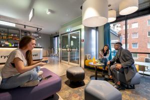 a group of people sitting in a waiting room at a&o Hamburg Hammer Kirche in Hamburg