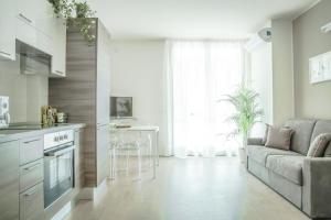 sala de estar con sofá y cocina en Alfa Bicocca Apartments, en Milán