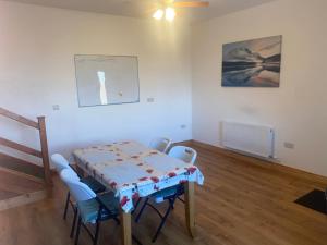 un comedor con mesa y sillas en una habitación en Connemara Chalet, en Galway