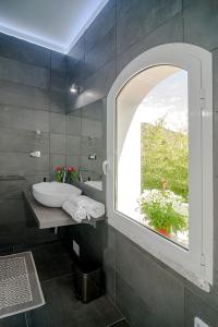 Maison27 في بودوني: حمام مع حوض ونافذة