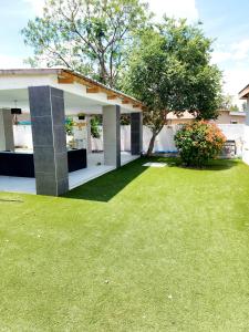 a house with a green lawn in front of it at Monaco villa Gaborone in Gaborone