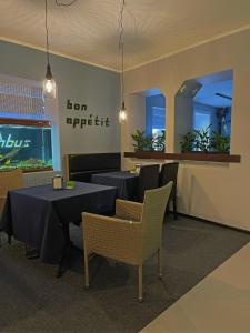 a restaurant with two tables and chairs and a fish tank at Rhombus Hotel in Luts'k