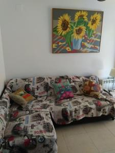 a living room with a couch with pillows at Apartamento en Port Saplaya in Port Saplaya