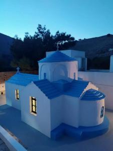 a white house with lights on top of it at Symi . VILLA CALME (Sur la Mer). in Symi