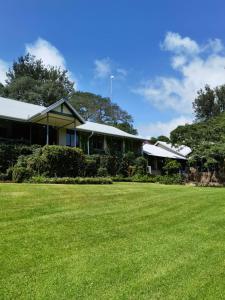 a house with a large lawn in front of it at Avoca Vale Country Hotel in Louis Trichardt