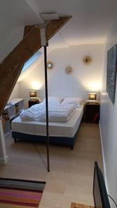 um quarto com uma cama num quarto com 2 candeeiros em Studio du Cairn em Wimereux
