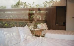 a hotel room with two beds and a window at West Lake Hotel - Near Bai Dai Beach in Thủy Triều