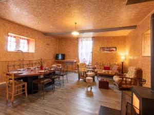 a living room with a table and a dining room at LES GRANGES D'ANTAN - La FORGE - in Chalonnes-sous-le-Lude