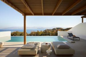 a patio with a view of the ocean from a house at PAROCKS Luxury Hotel & Spa in Ambelas