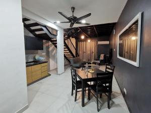 a dining room with a table and a ceiling fan at Lakeview Duplex Apartment Free WiFi and Netflix in Cyberjaya