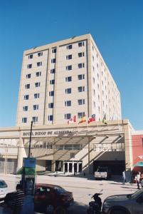 a large building with cars parked in front of it at Hotel Diego de Almagro Copiapo in Copiapó