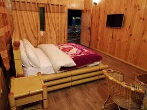 a bedroom with a bed in a wooden room at Swiss Wood Cottages Naran in Nārān +29 photos