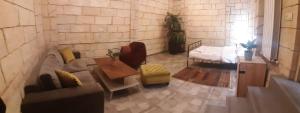 a living room with a couch and a bed at Retro Hostel & Tours in Yerevan