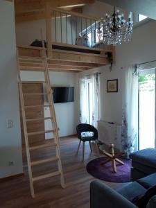 a room with a loft bed and a living room at Gästehaus Andreas in Schönsee