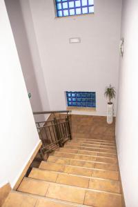 a hallway with a wooden floor and a window at Weranda Rooms in Tychy