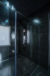 a bathroom with a shower with a glass door at Marmur Suite in Palermo