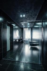 a bathroom with a glass shower and a sink at Marmur Suite in Palermo +35 photos