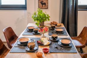 una mesa con platos de comida y fruta. en Ferienwohnungen Gut Fasanenhöhe en Chieming