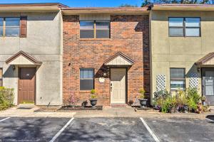 a brick house with a parking lot at Fort Walton Beach Townhome Less Than 3 Mi to the Beach! in Fort Walton Beach