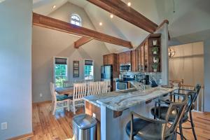 a kitchen with a large island with bar stools at Family-Friendly Lake Lanier Escape on 2 and Acres! in Gainesville