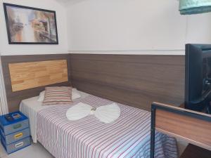 En eller flere senger på et rom på Pousada Soft Brooklin