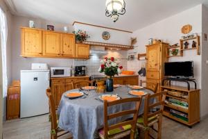 a kitchen with a table with a vase of flowers on it at La Tourette in Cauterets