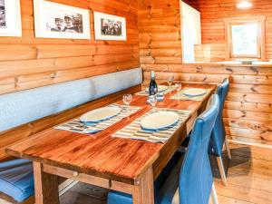a dining room with a wooden table and chairs at Traditional chalet with garden near Malmedy in Malmedy