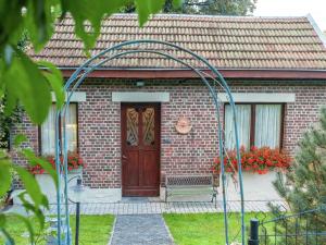 ein Backsteinhaus mit einer Holztür und einem Tor in der Unterkunft Holiday Home in Malmedy with terrace in Malmedy