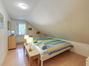 a bedroom with a bed and a table with a lamp at Finnish holiday villa with sauna in Norg