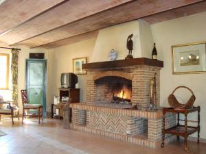 a living room with a large brick fireplace at Alluring Cottage in Englancourt with Fenced Garden in Englancourt