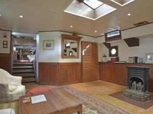 a living room with a fireplace and a stove at Charming Boat in Villedubert with Terrace in Villedubert