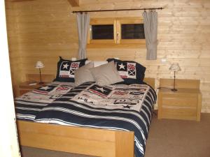 - une chambre avec un lit dans une cabane en rondins dans l'établissement Sunny Chalet in Les Gets with Jacuzzi, aux Gets