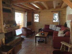 a living room with a couch and a fireplace at Sunny Chalet in Les Gets with Jacuzzi in Les Gets