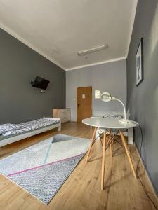 a living room with a table and a bed at Moon Hostel Warszawa in Warsaw