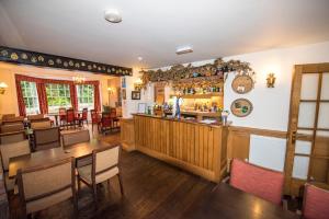 ein Restaurant mit Bar sowie Tischen und Stühlen in der Unterkunft The Frocester in Stonehouse