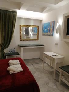 a hotel room with a red bed and a mirror at Federico 70 Giada Economy in Palermo