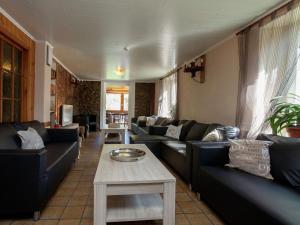 sala de estar con sofás y mesa en Spacious house in Borgoumont with jacuzzi and large garden, en Stoumont