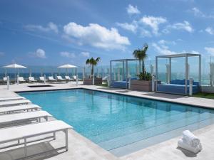 a swimming pool on the roof of a building at Grand Beach Hotel Surfside in Miami Beach