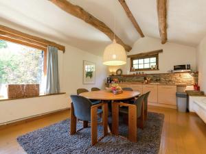 a kitchen and dining room with a wooden table and chairs at Tastefully furnished holiday residence located in the heart of the Ardennes in Houffalize