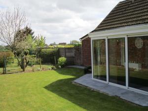 a conservatory in a house with a yard at Modern Holiday Home in Hollebeke with Private Garden in Zandvoorde