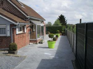 a brick house with a fence and a sidewalk at Modern Holiday Home in Hollebeke with Private Garden in Zandvoorde