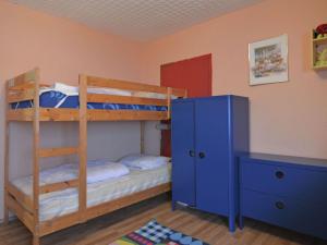 a bedroom with two bunk beds and a blue cabinet at Holiday home near the ski lift in Winterberg
