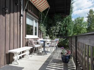 a patio with a table and chairs next to a building at Homey Chalet in Breitenbrunn Rittersgrun in Breitenbrunn